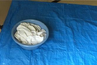 タオルの入ったバケツで雨漏りを受け止める