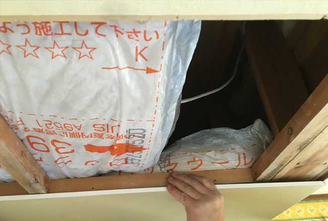 新しく断熱材を天井裏に敷設する様子